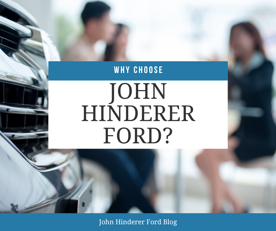 A couple purchasing a vehicle at a car dealership and the text: Why Choose John Hinderer Ford?