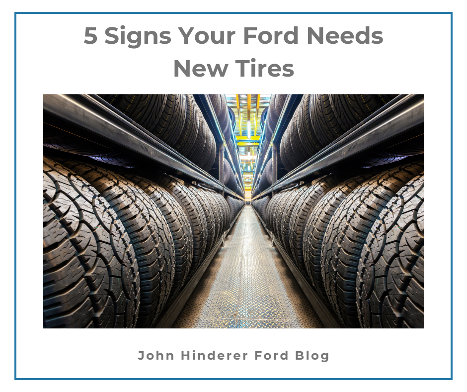 A graphic containing a photo of tires in a warehouse and the text: 5 Signs Your Ford Needs New Tires - John Hinderer Ford Blog